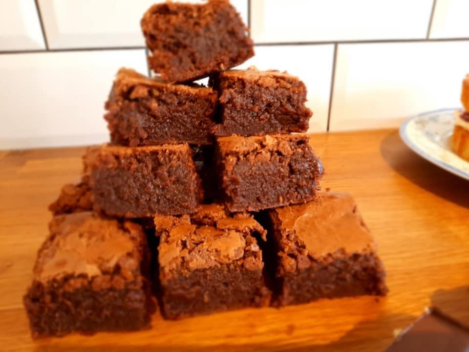 A tray of rich home-baked chocolate brownies cut into squares