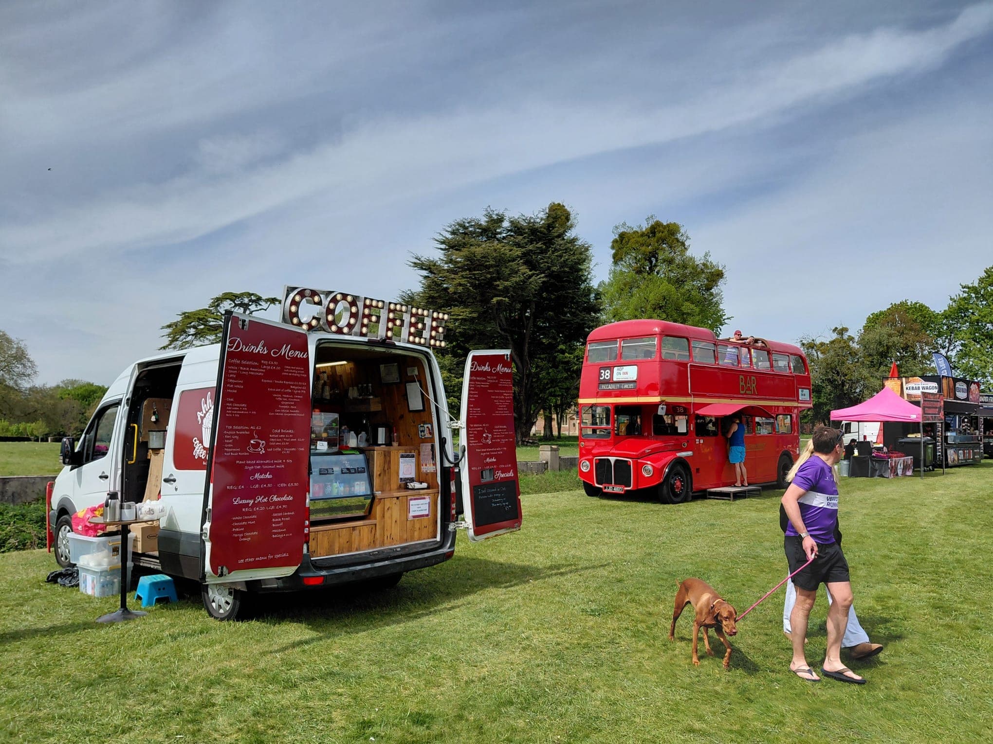 Ahh Roma coffee van open at a summer event with a vintage red double-decker bus bar in the background
